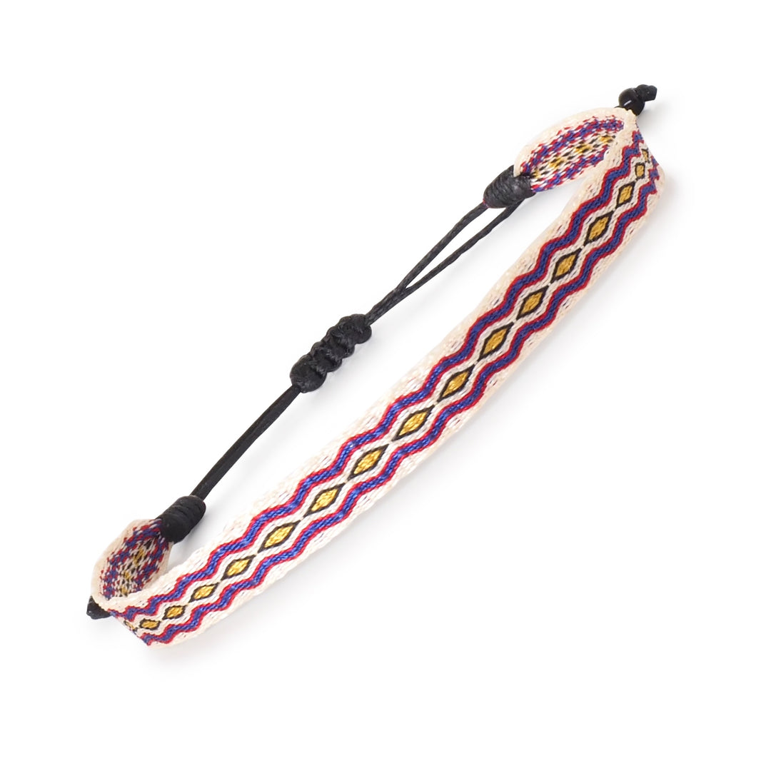 Handwoven beige, blue, and yellow surfer bracelet with diamond pattern and adjustable cord. Handmade by artisans in Colombia.