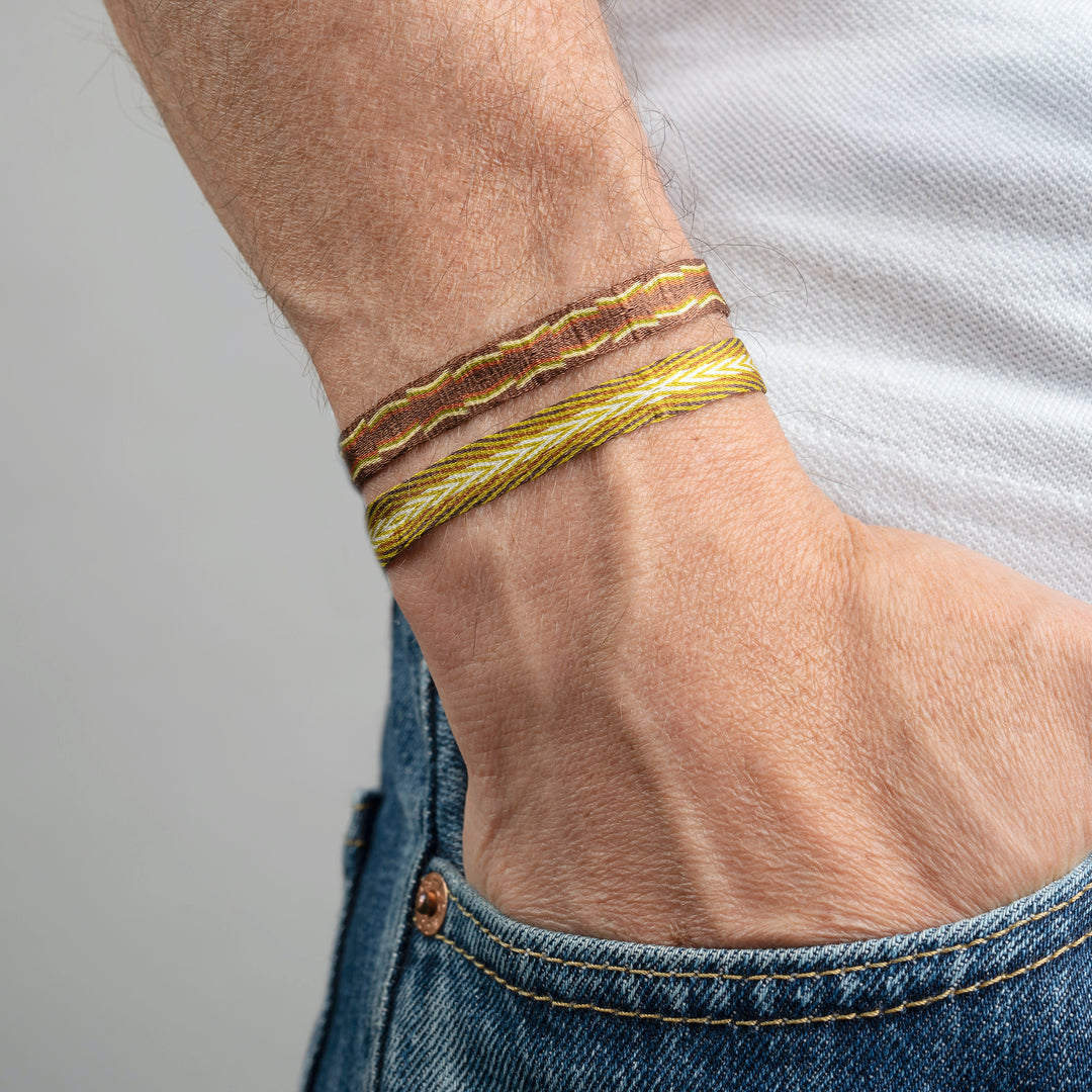 Handwoven Egyptian Loom Brown and Yellow Surfer Bracelet on wrist.