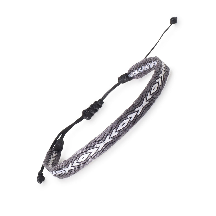 Handwoven men's surfer bracelet in grey, white, and black with a diamond pattern; waterproof and adjustable.