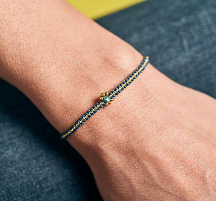 Close-up of an Adjustable Dainty Daisy Bracelet, handcrafted in Colombia. Color Blue.