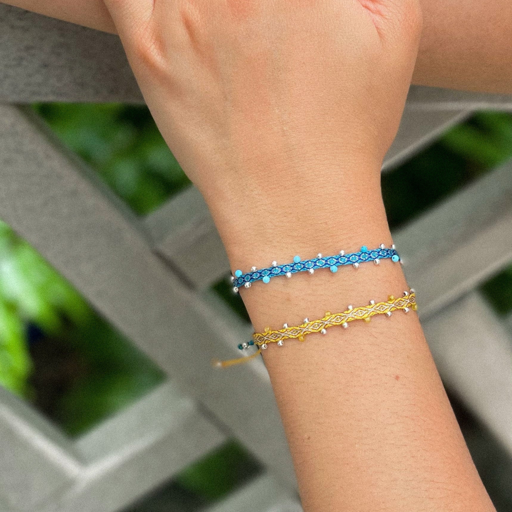 Egyptian Loom Bracelet Blue and Yellow Chakras Bracelet, with gemstones on model, 40 threads bracelet