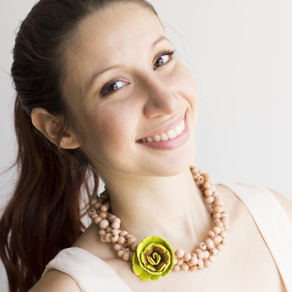 Flor Braided Necklace, with an orange peel flower. Lime flower with rose acai beads on model
